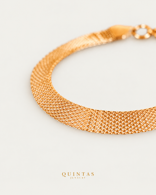 Belinda Woven Gold Bracelet gold bracelet companion photographed angle on neutral greige