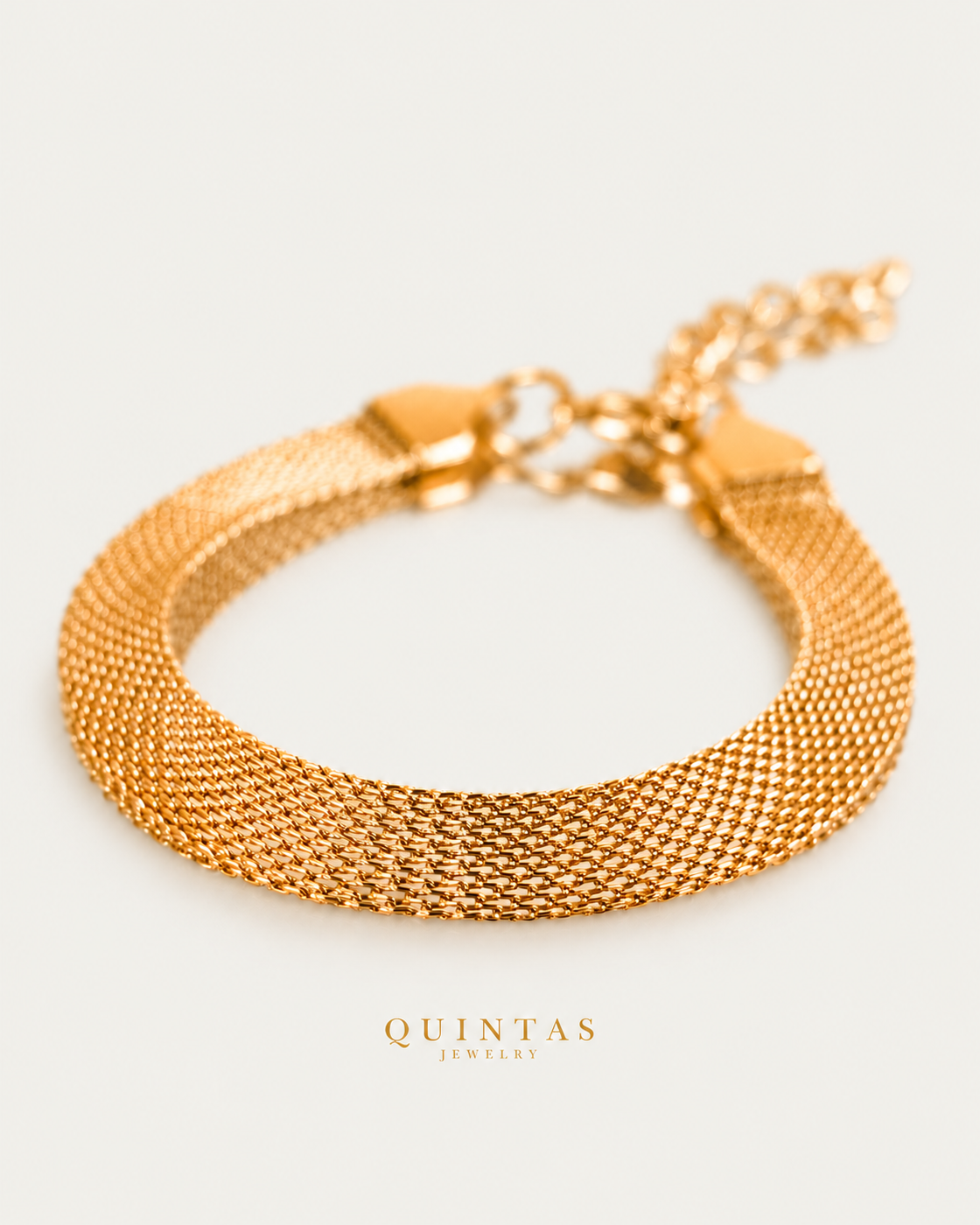 Belinda Woven Gold Bracelet gold bracelet hero photographed angle on neutral greige