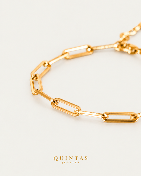 QUINTAS Paperclip Bracelet gold bracelet companion photographed angle on neutral greige