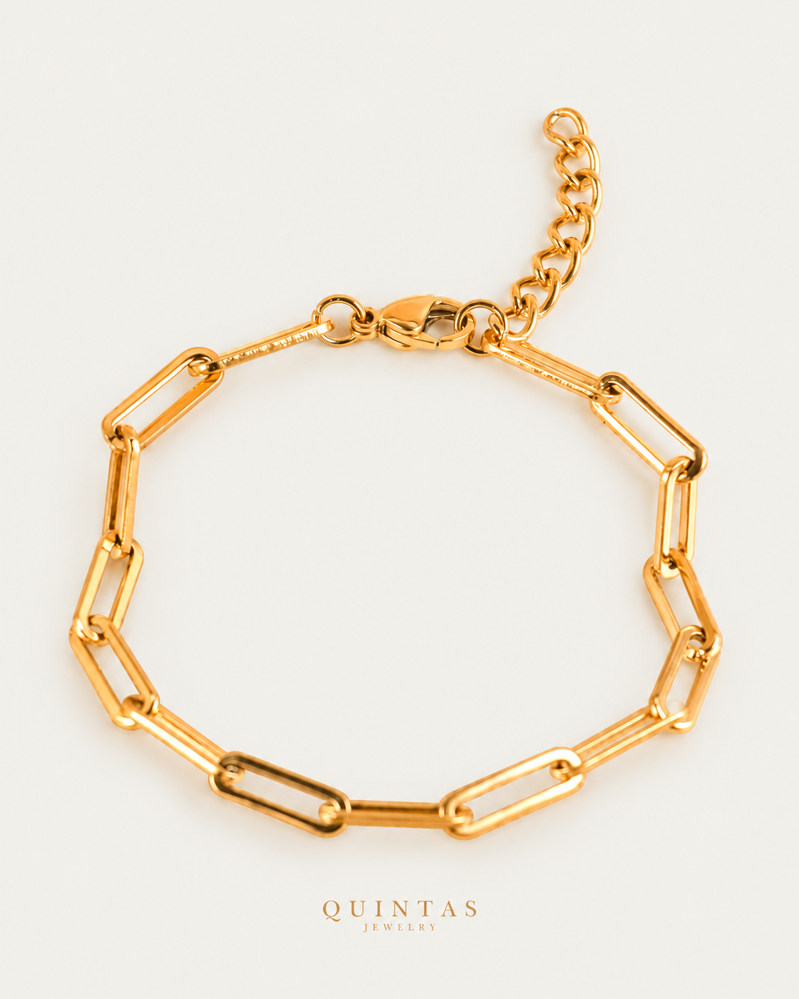 QUINTAS Paperclip Bracelet gold bracelet hero photographed angle on neutral greige