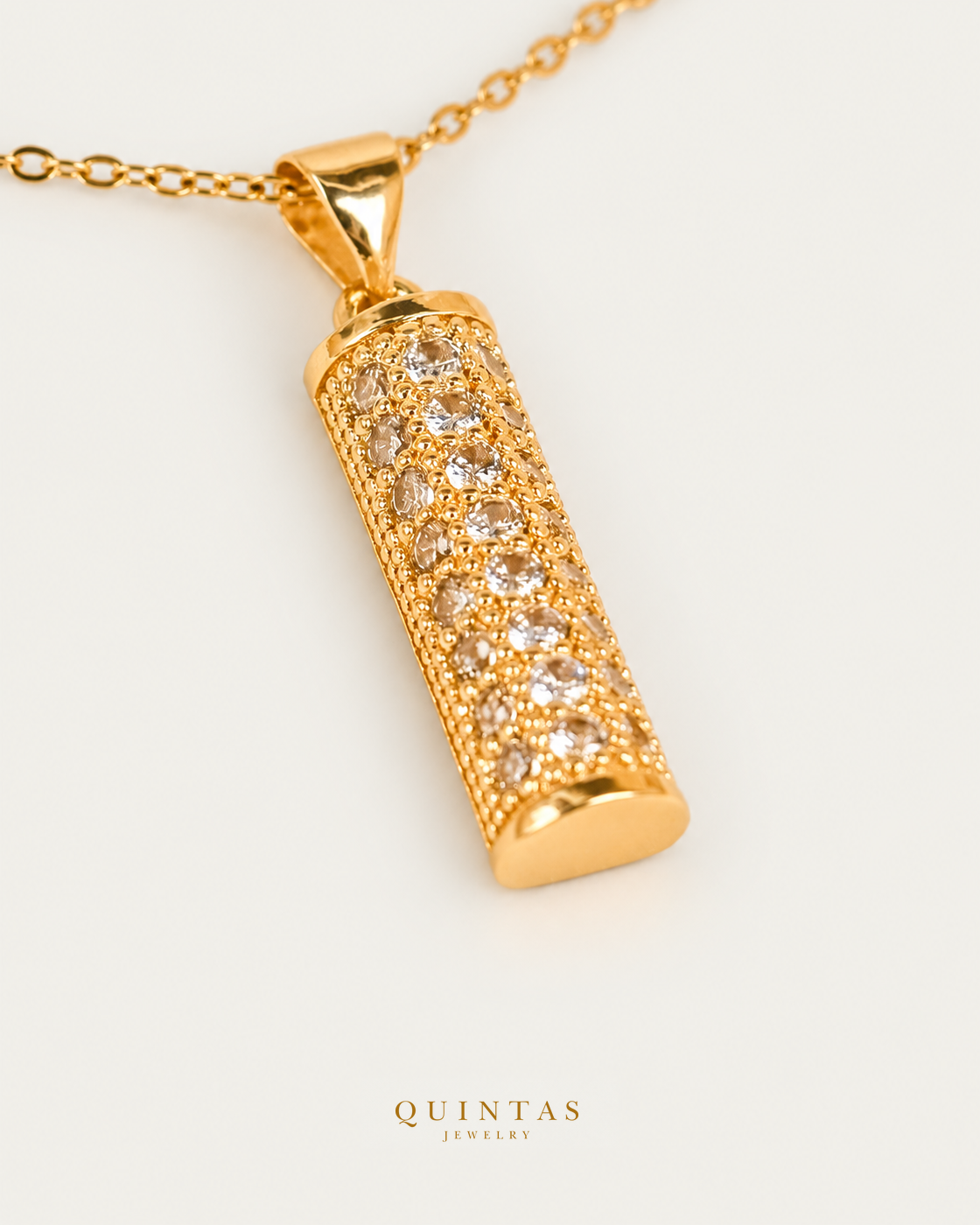 Rocco Gold Bar Necklace — source-verified cable oblique view, off-white background, canonical gold logo