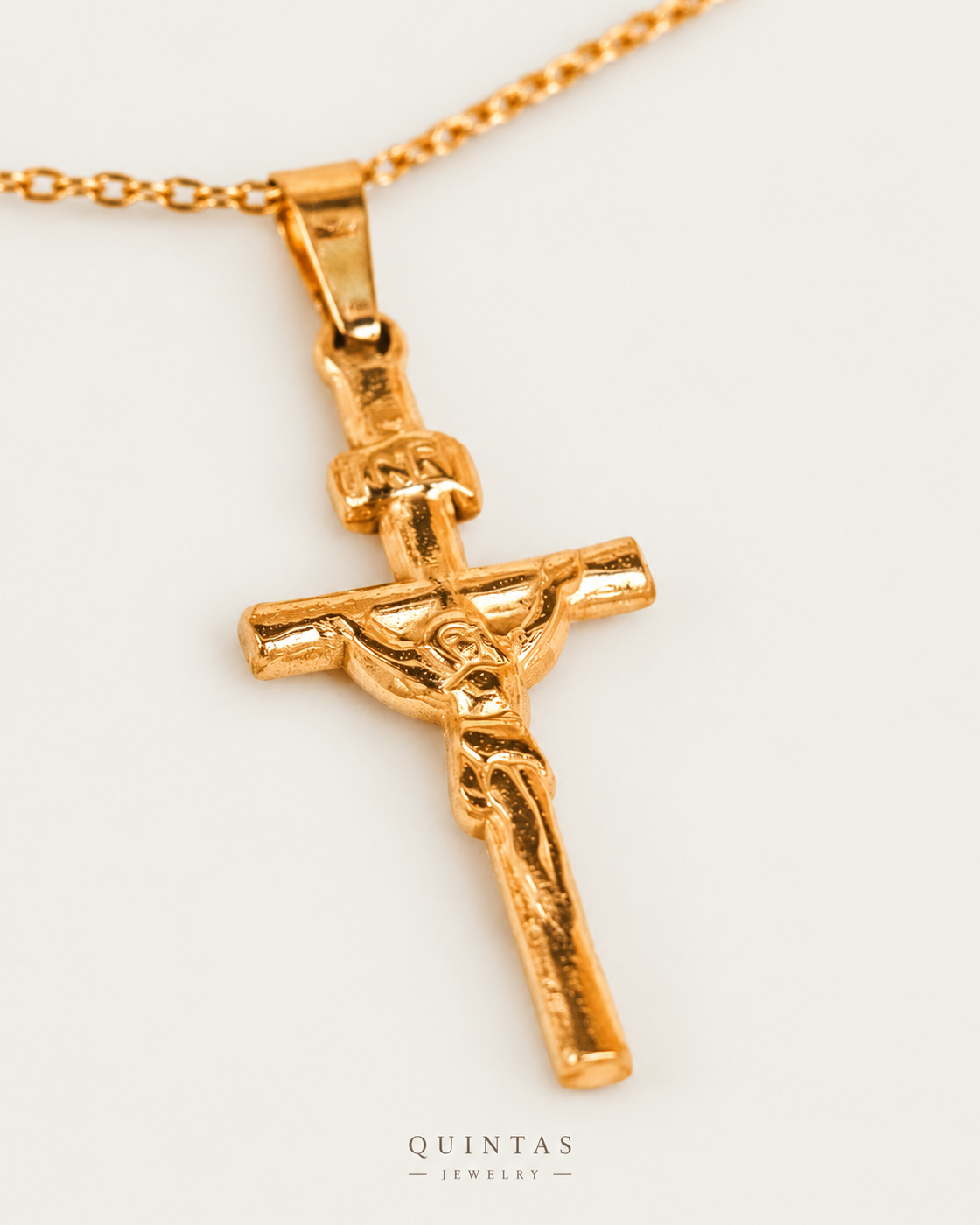 Jesus Crucifix Necklace — gold cable chain, genuine oblique angle, neutral greige
