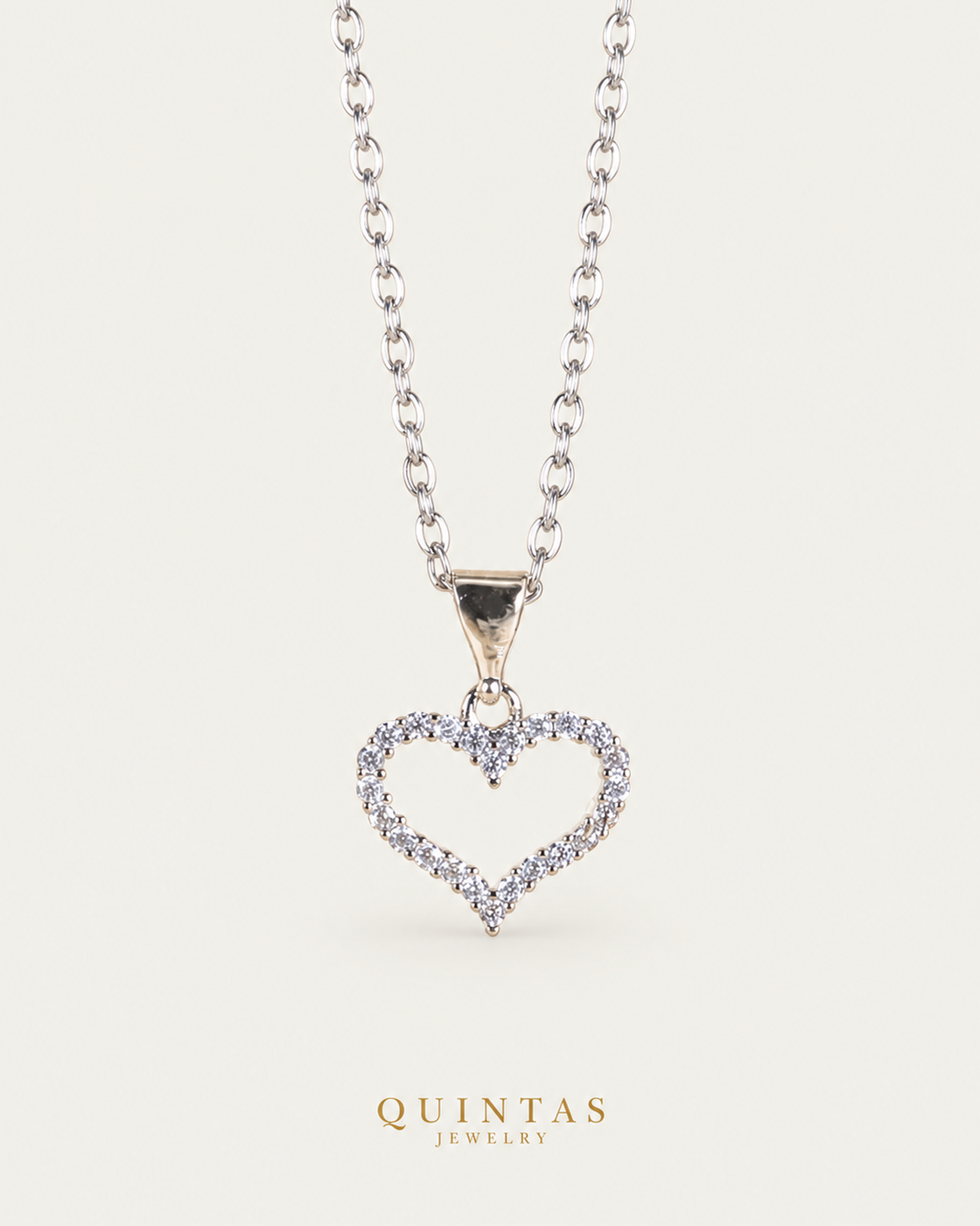 Althea Iced Heart Silver Necklace cable hero photographed angle on neutral greige