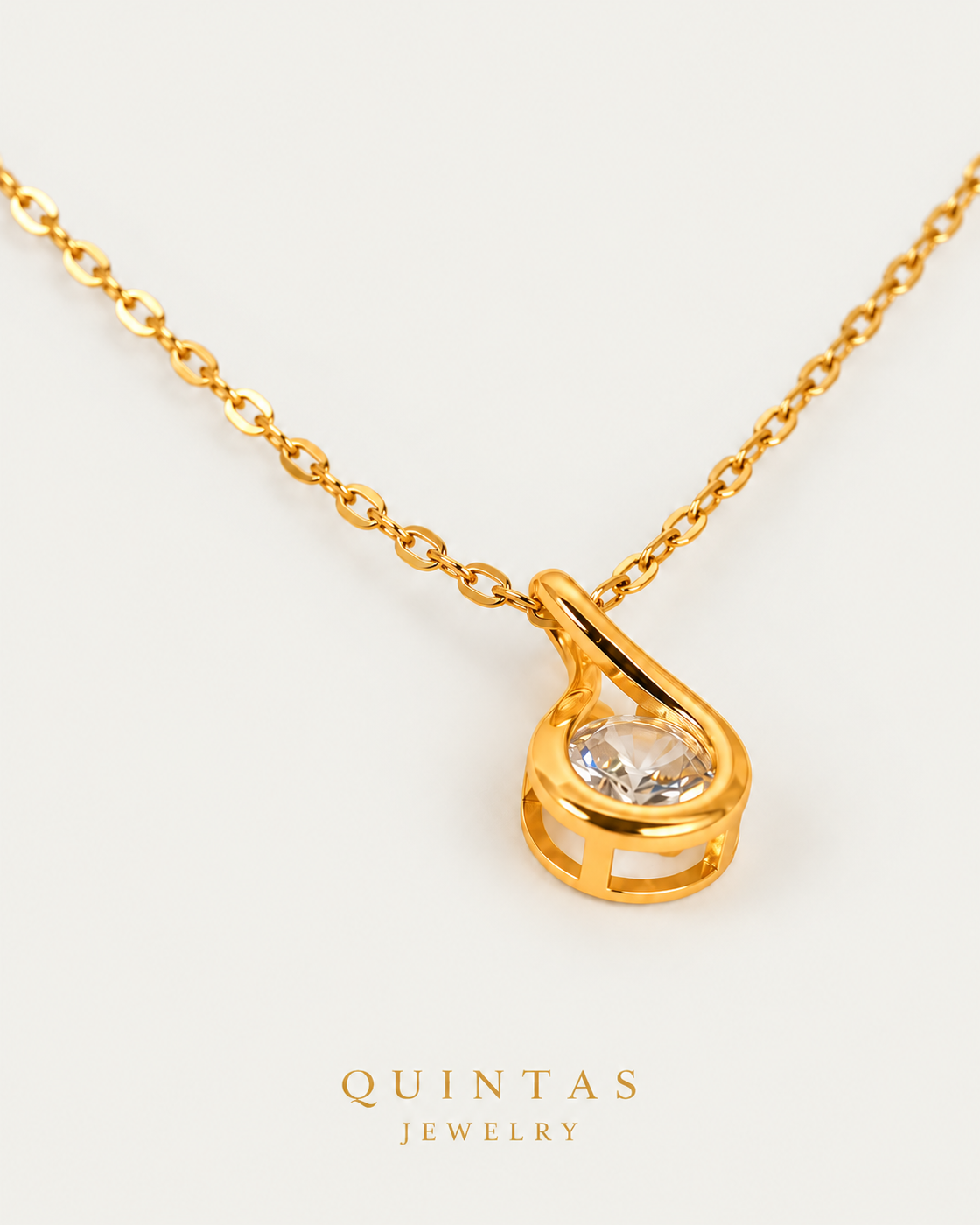 Solitaire Teardrop Necklace cable chain companion photographed angle on neutral greige