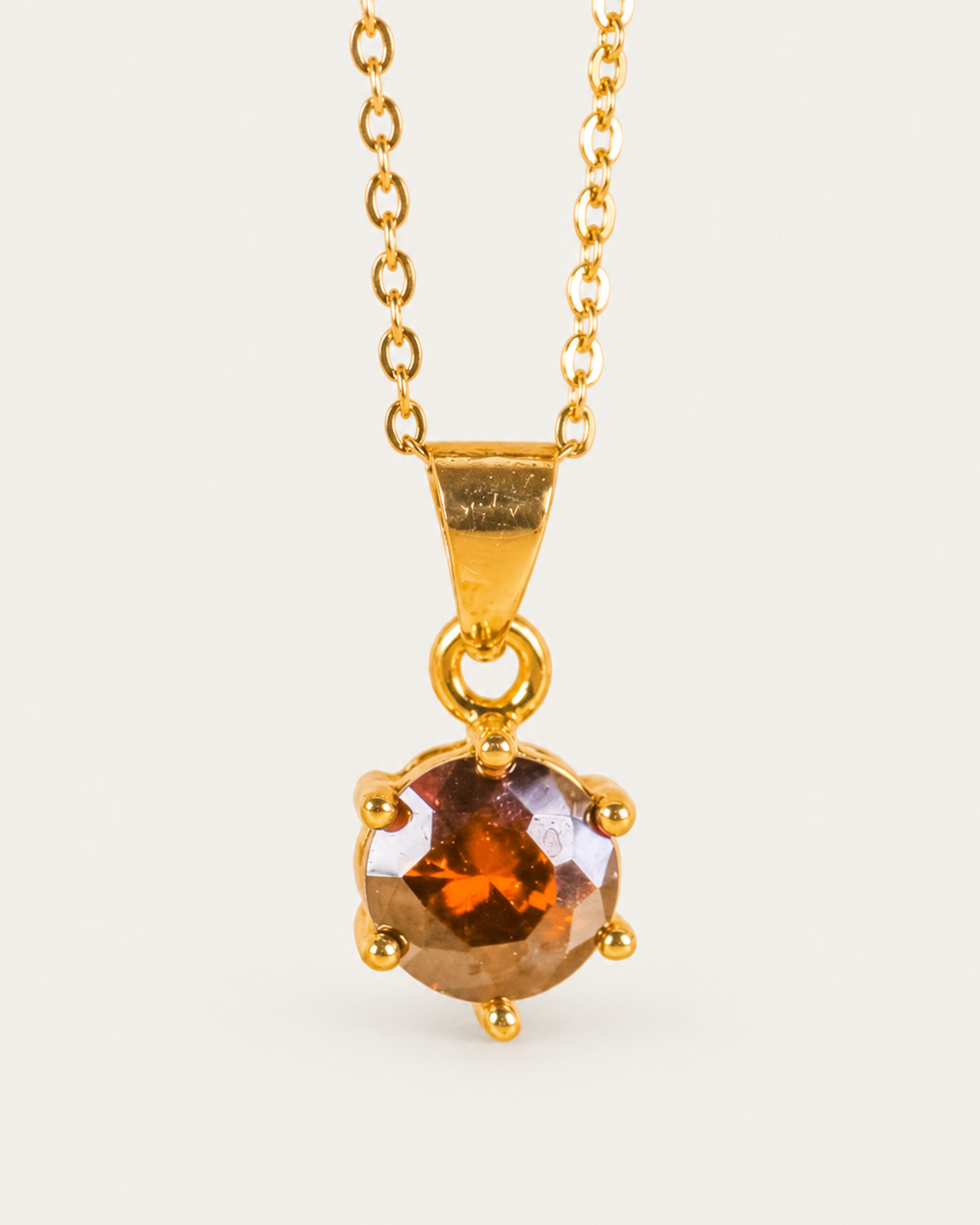 Brilliant Gemstone Amber cable chain hero photographed angle on neutral greige