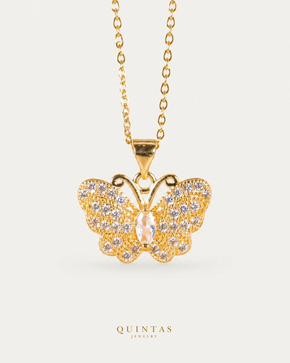 Jane Butterfly Diamond Necklace — gold cable, frontal hero, neutral greige; canonical Quintas Jewelry logo
