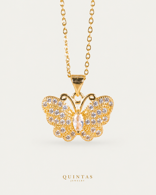Jane Butterfly Diamond Necklace — gold cable, frontal hero, neutral greige; canonical Quintas Jewelry logo
