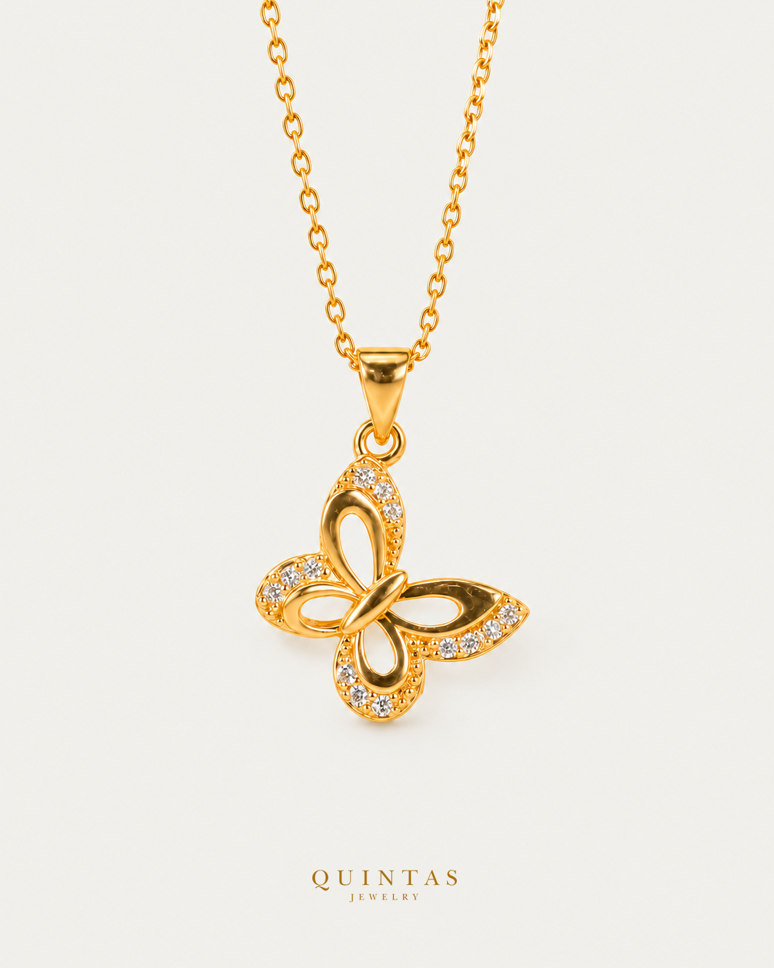 Marinella Butterfly Necklace — neutral greige; canonical Quintas Jewelry logo