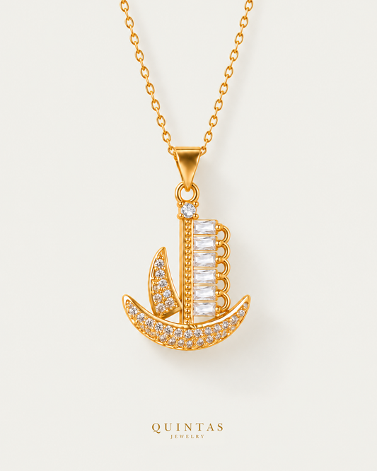 Voyager Ship Charm Necklace hero with canonical Quintas Jewelry logo
