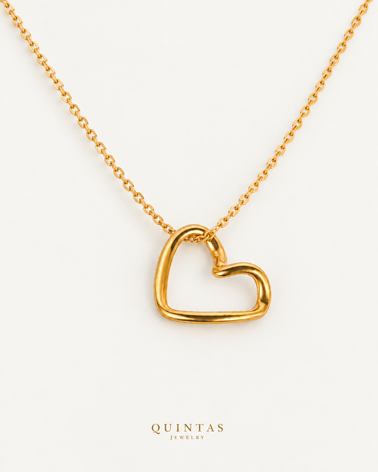 Alina Heart Necklace — source-verified cable oblique view, off-white background, canonical gold logo