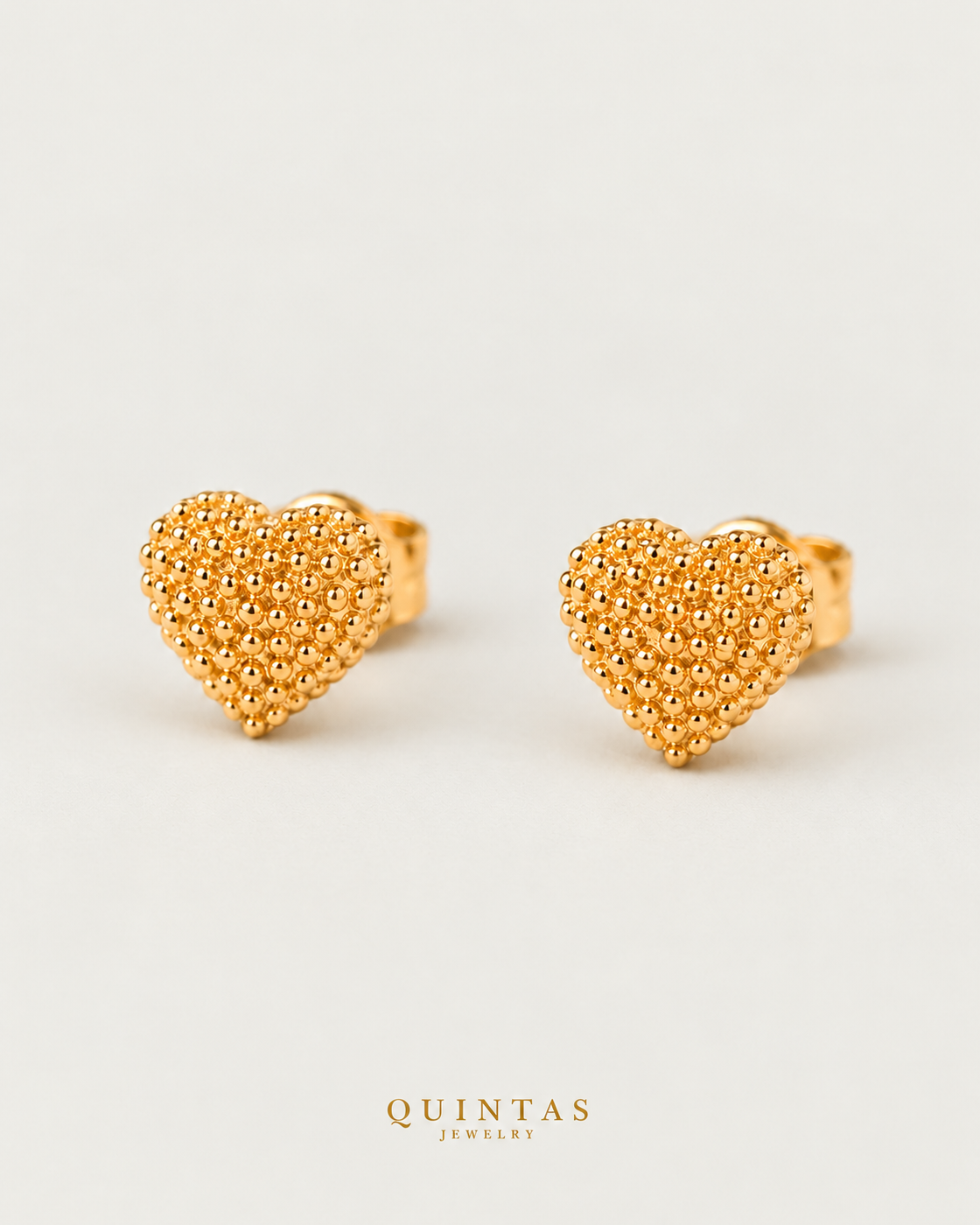 Amara Heart Stud Earrings, yellow gold earrings, neutral greige background