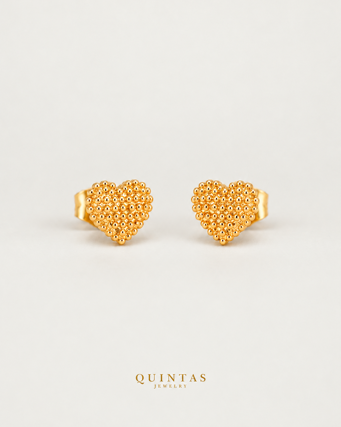 Amara Heart Stud Earrings, yellow gold earrings, neutral greige background