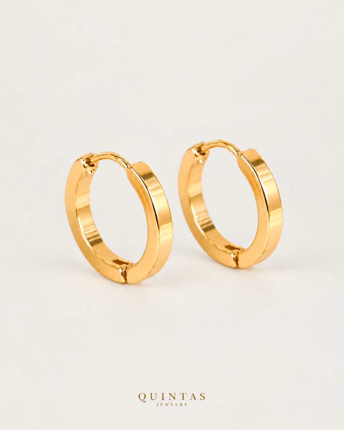 Arabella Golden Hoop Earrings, yellow gold hoop pair, neutral greige background