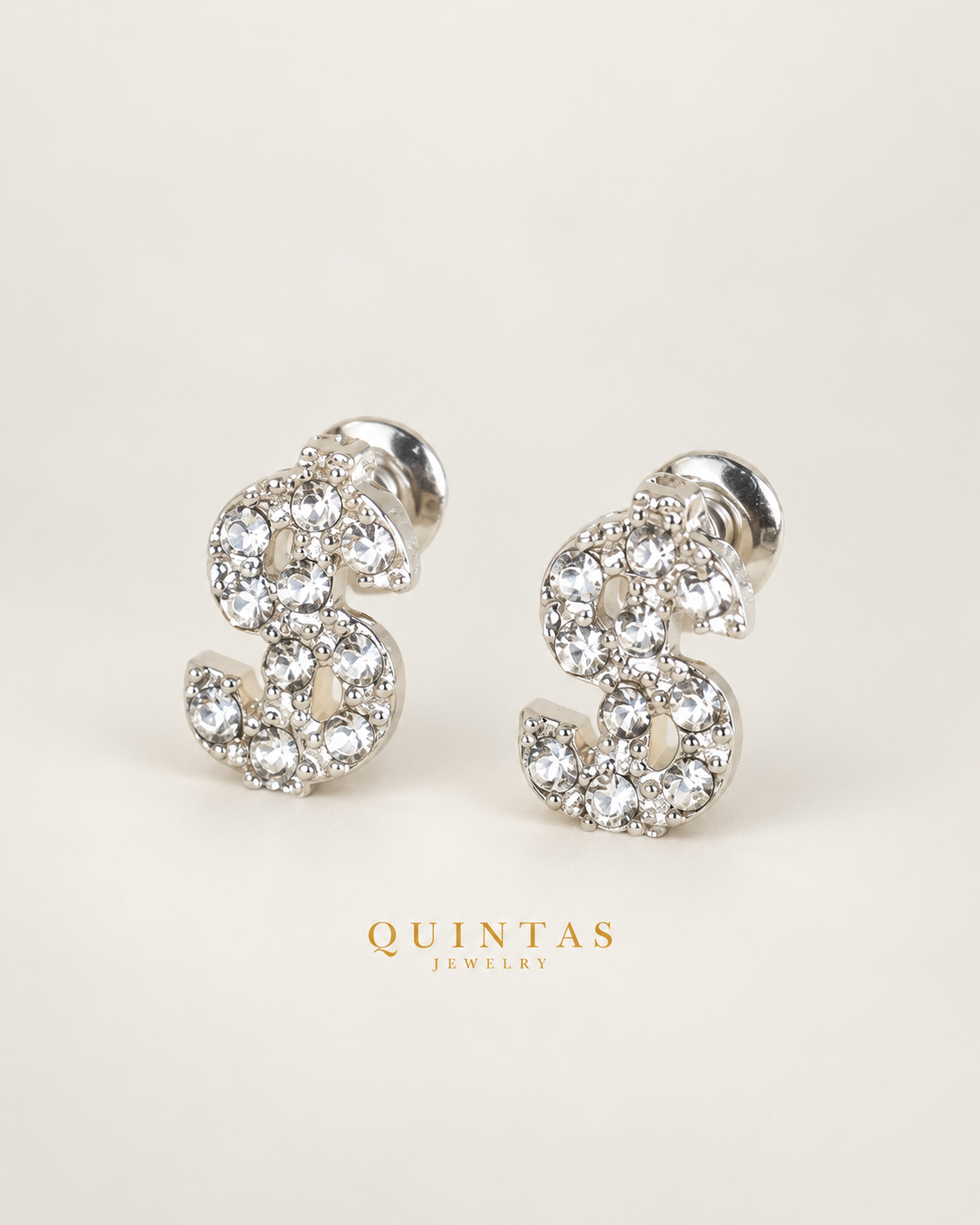 Dollar Sign silver stud earrings — hero, neutral greige