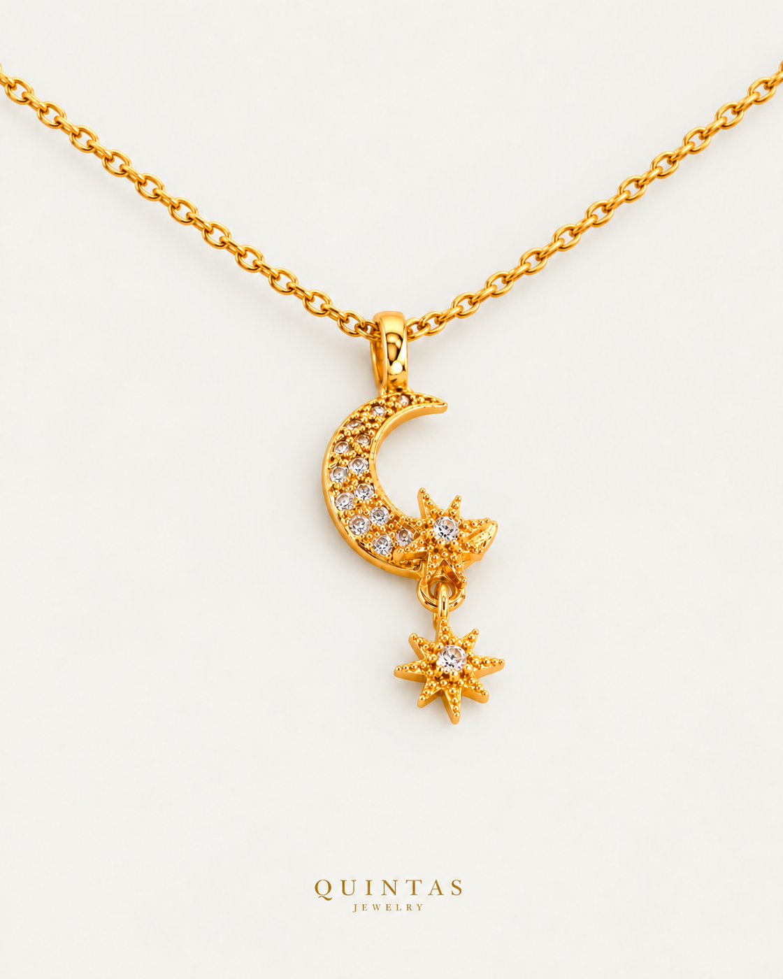Gaia Moon and Star Necklace, gold cable chain oblique view, neutral background and canonical logo