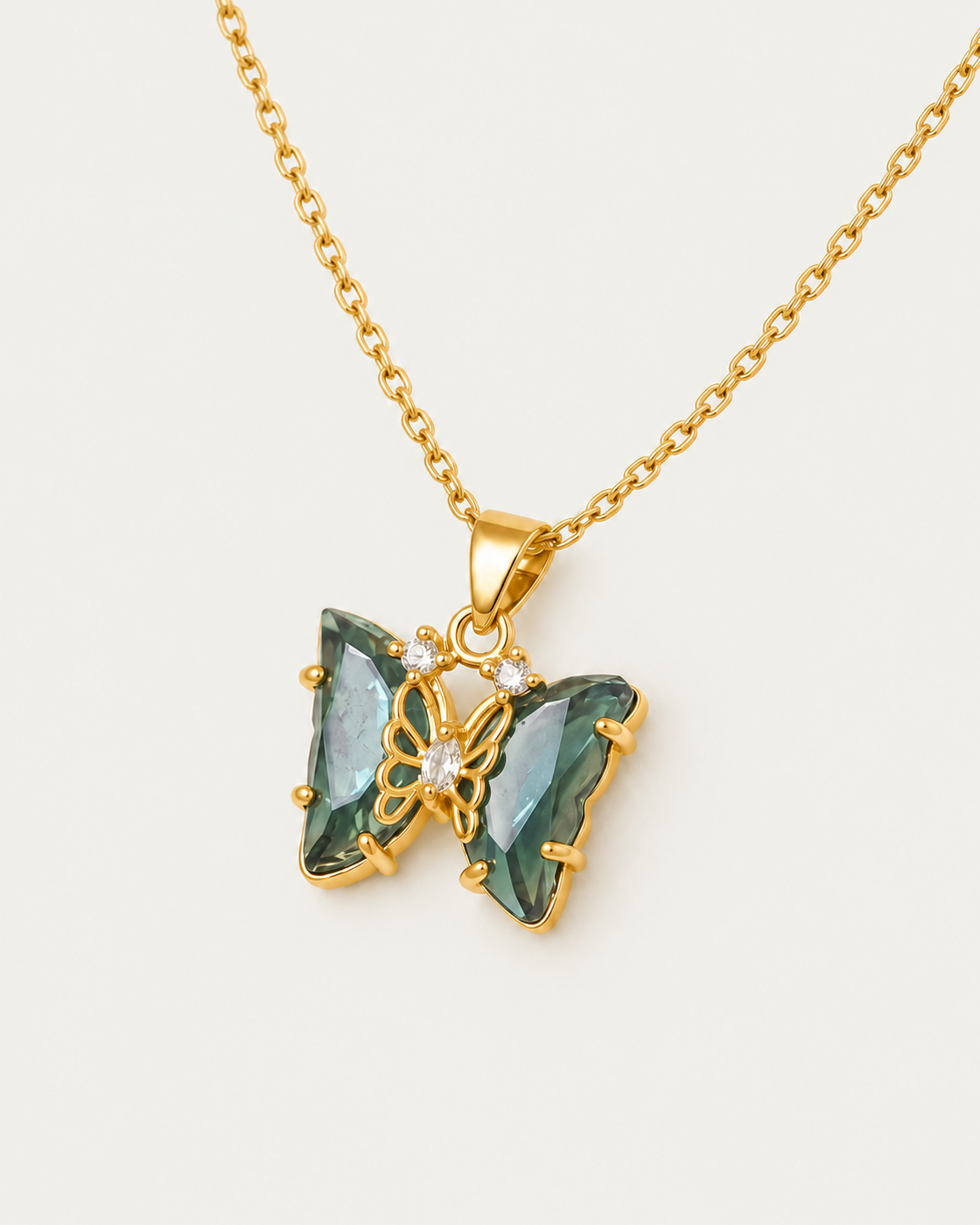 Gemstone Butterfly Necklace — Green / actual cable-chain oblique view, neutral greige