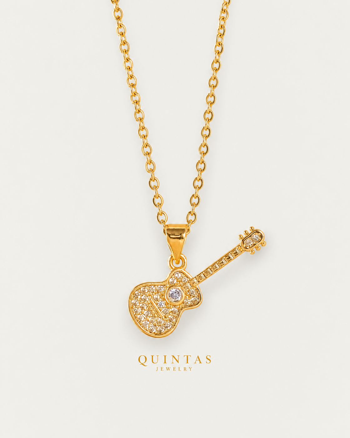 The Guitar Necklace gold cable chain hero on neutral greige