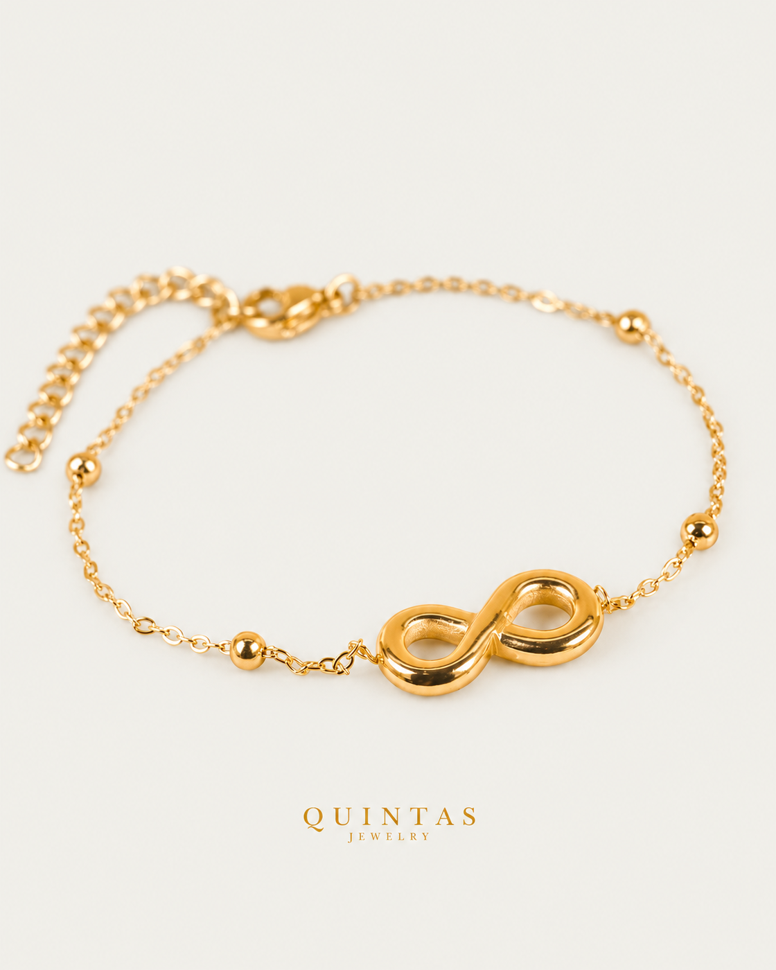 Infinity Charm Bracelet, full physical-source view, neutral greige