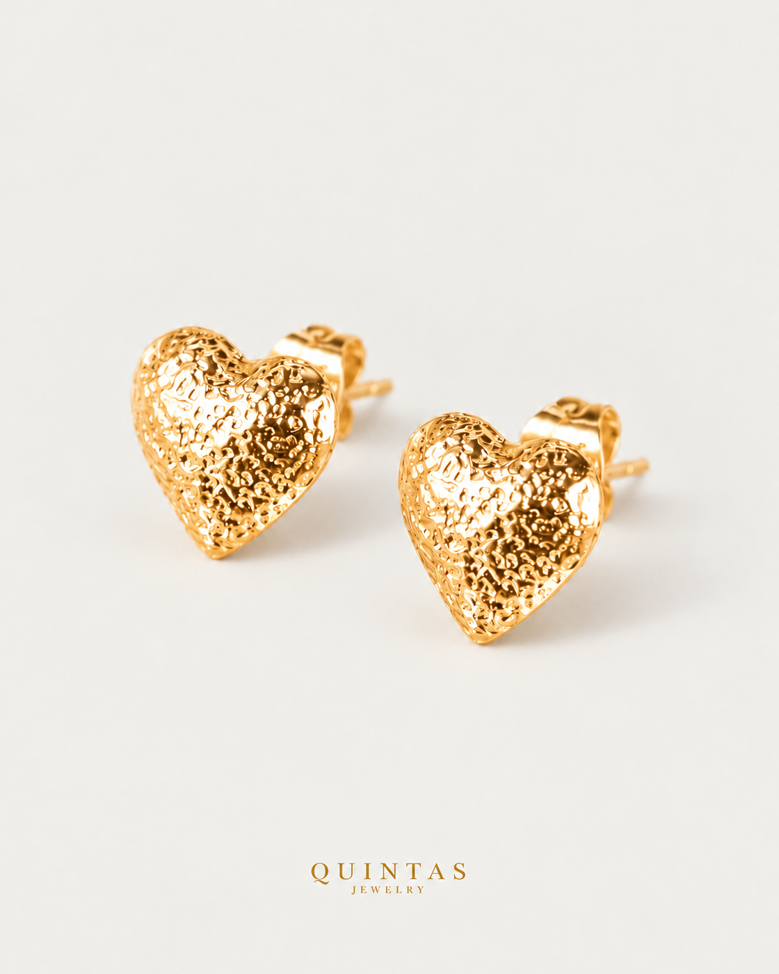 Vivere Heart Stud Earrings, yellow gold stud earrings, neutral greige background