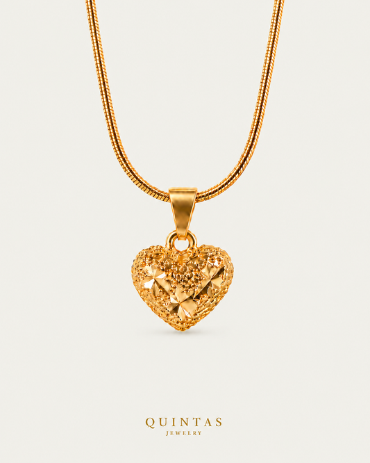 Zarina Heart Necklace on premium snake chain on a neutral greige background with a faint soft shadow