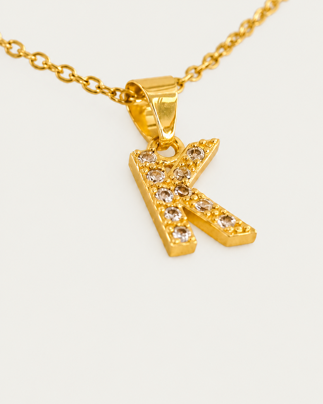QUINTAS Zirconia Letter Initial Necklace — K / actual cable-chain oblique view, neutral greige