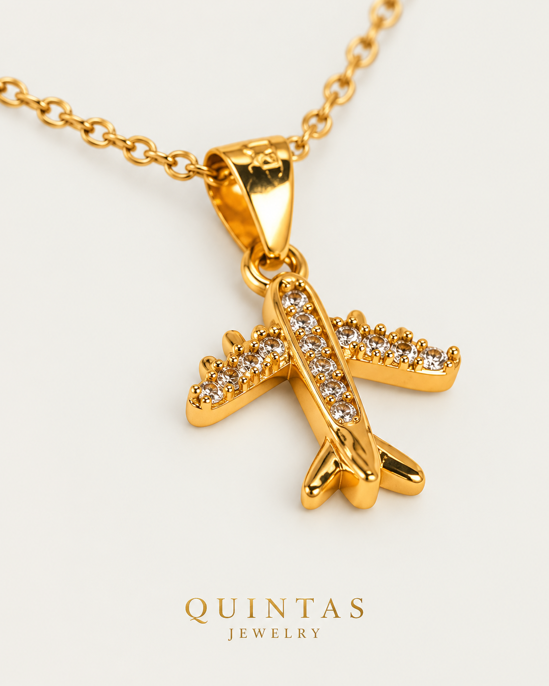 Wanderlust Airplane — cable chain, genuine oblique detail, neutral greige background