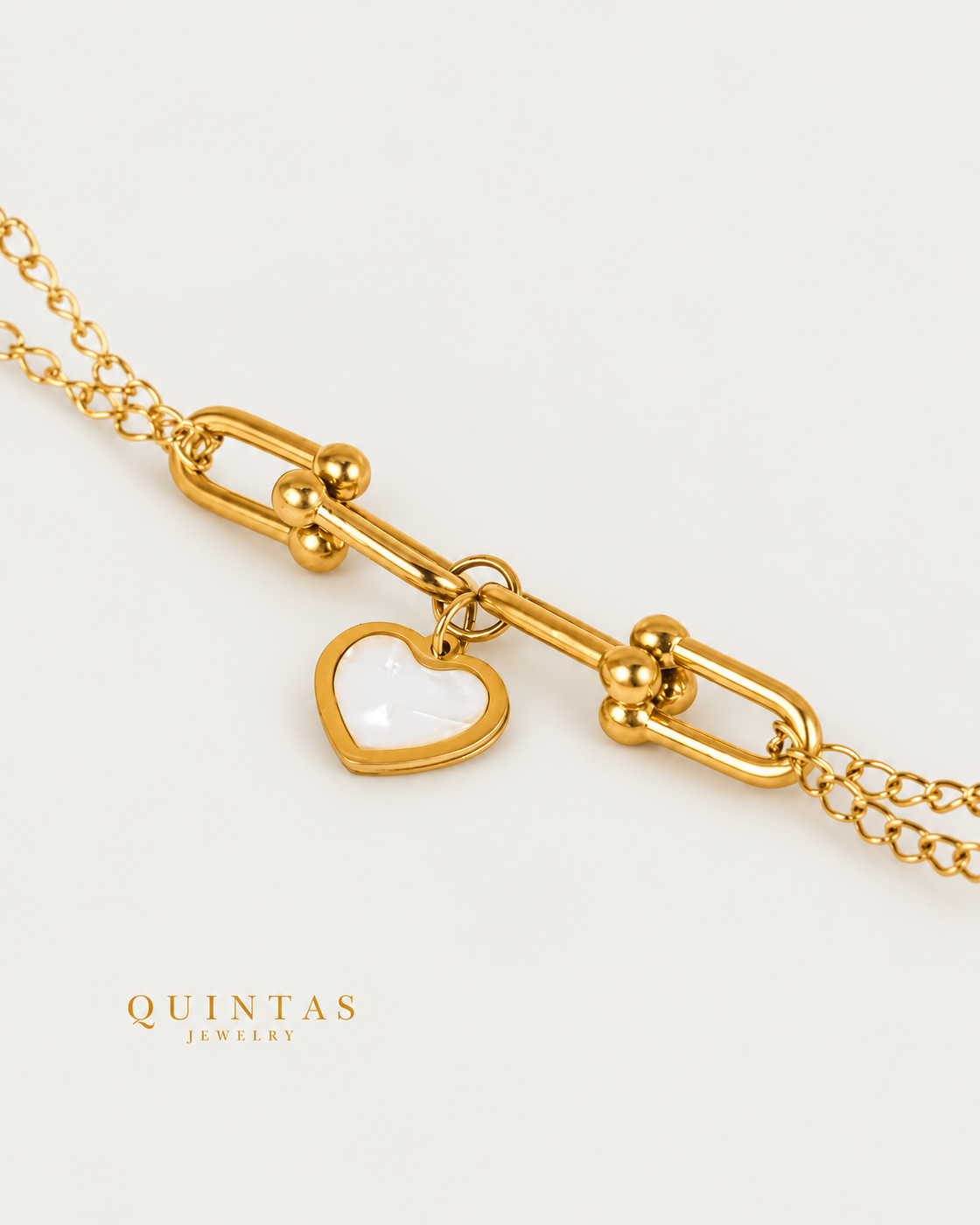 White Heart Link Bracelet — gold bracelet, genuine oblique detail, neutral greige background
