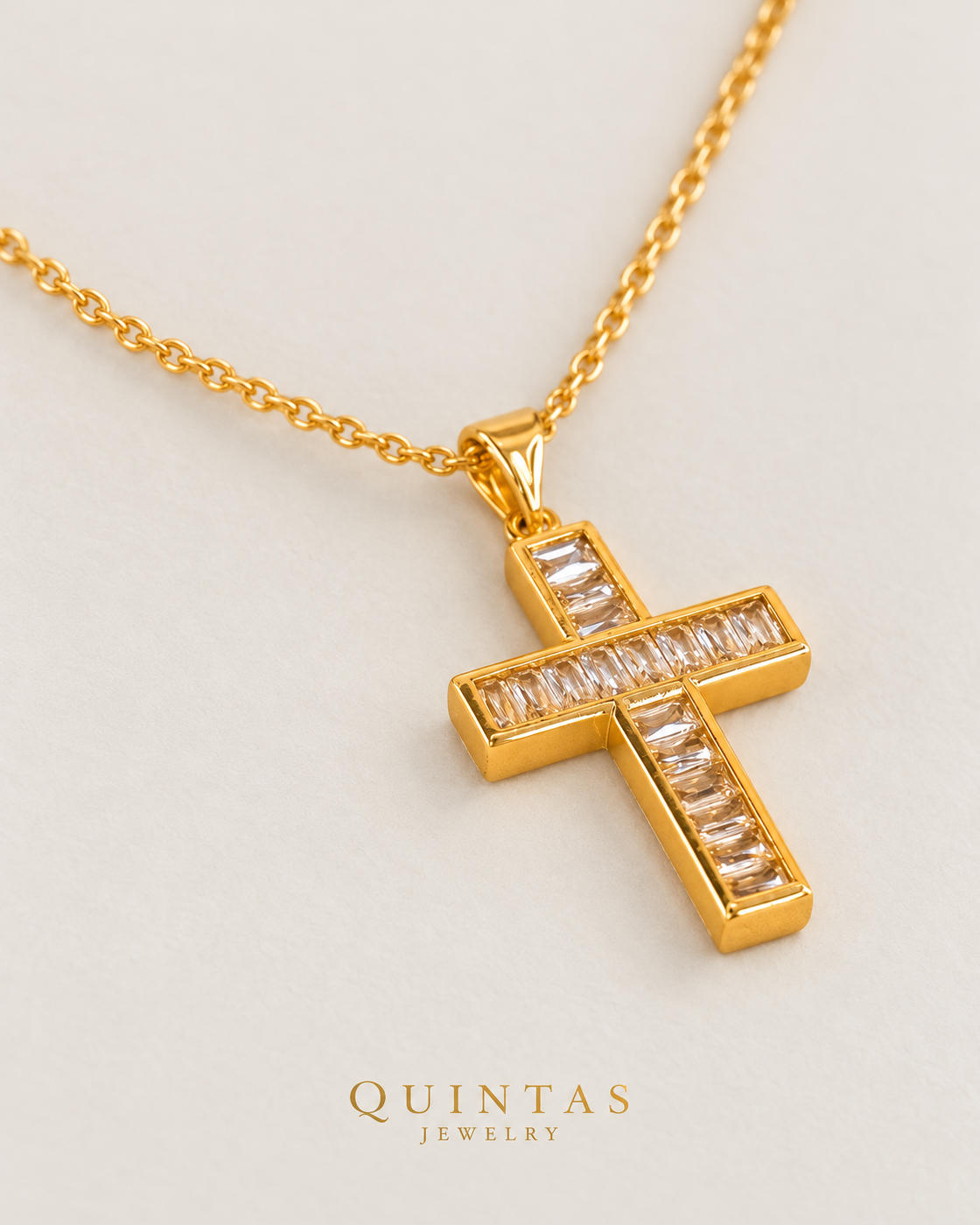 Bold Iced Cross Necklace — gold cable chain, lying oblique view, neutral greige